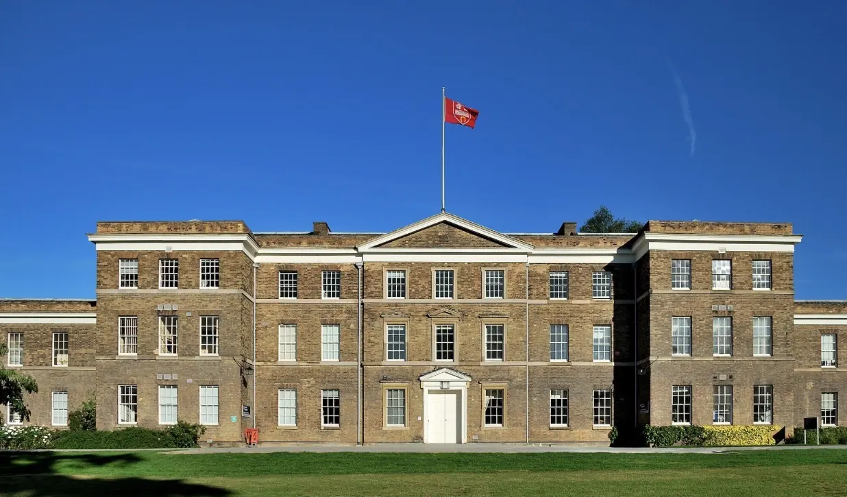 A University of Leicester building: a long brick Georgian façade under a clear blue sky.