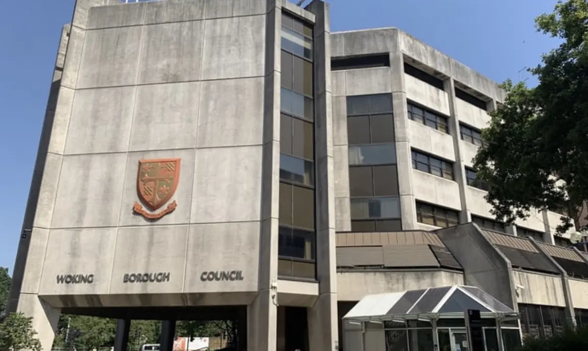 Woking Borough Council civic offices, a concrete building with the borough crest above the entrance.